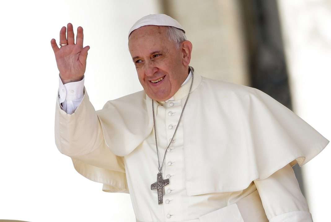 Pope Francis waves as he leads his weekly audience in Saint Peter's Square at the Vatican