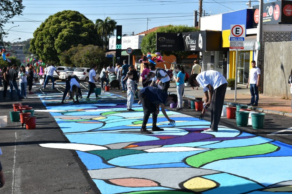 Voluntários se empenham para montar os tapetes para a procissão de Corpus Christi em Matão.  — Foto: Gabrielle Chagas/G1